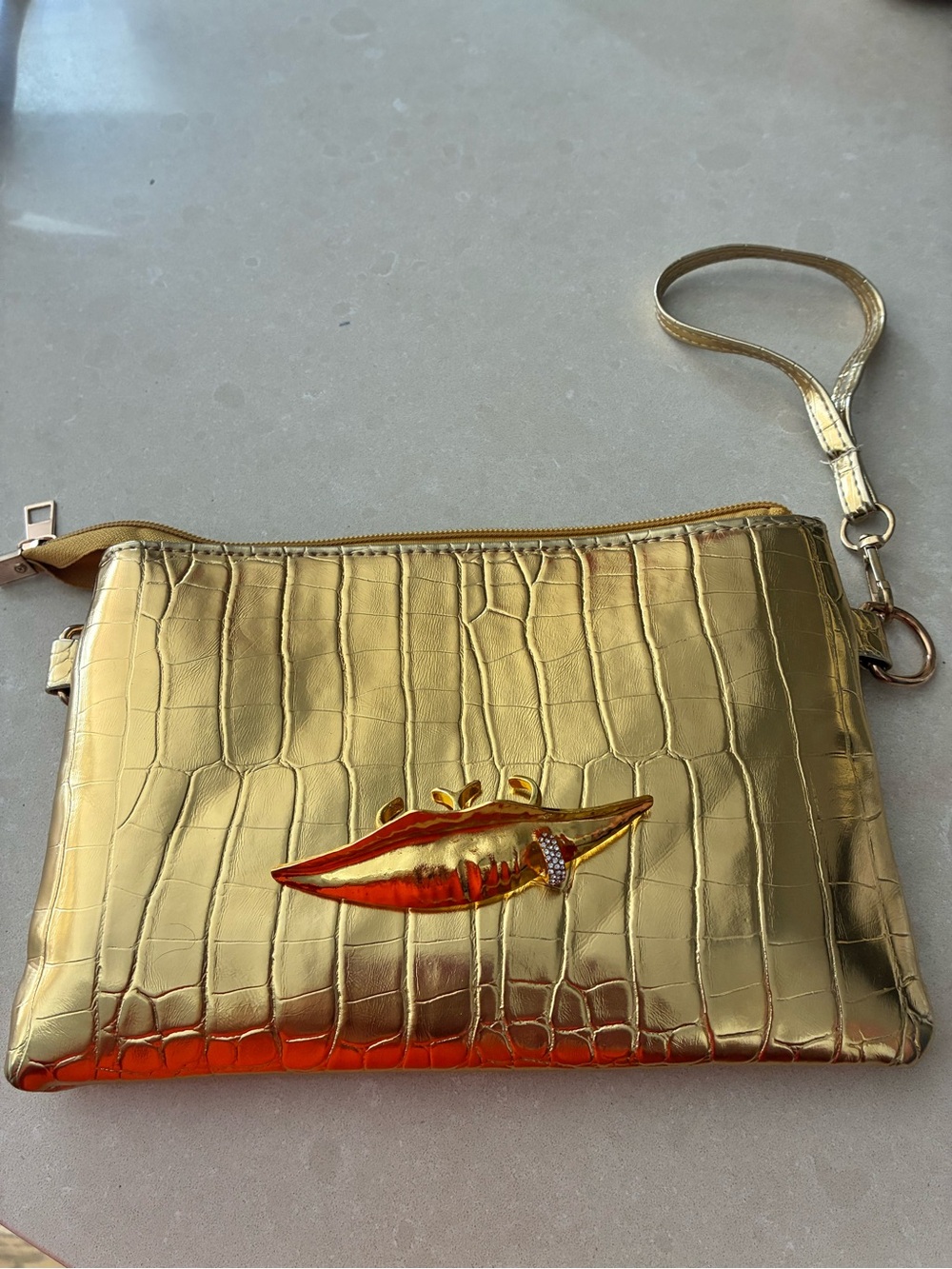 Gold Croc-Embossed Wristlet Clutch with Lip Motif Ring